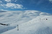 Røldal Ski Resort with ski lifts and white slopes under a clear blue sky.