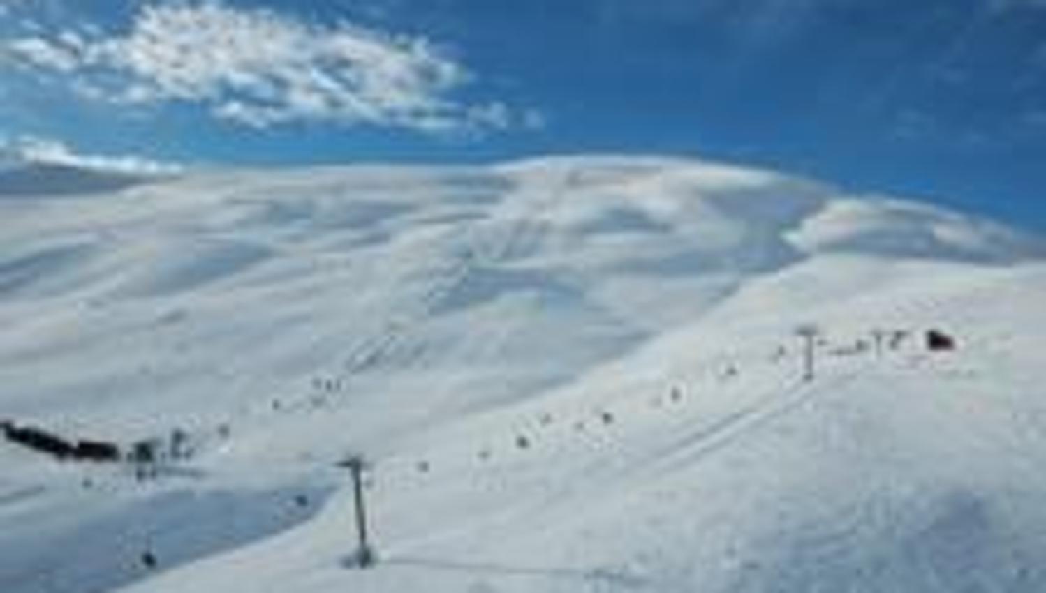 Røldal Ski Resort with ski lifts and white slopes under a clear blue sky.