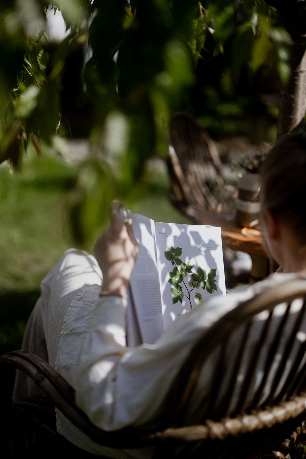 Guest enjoying a peaceful morning with a book in the garden at Hotel Sundal in scenic Hardanger.