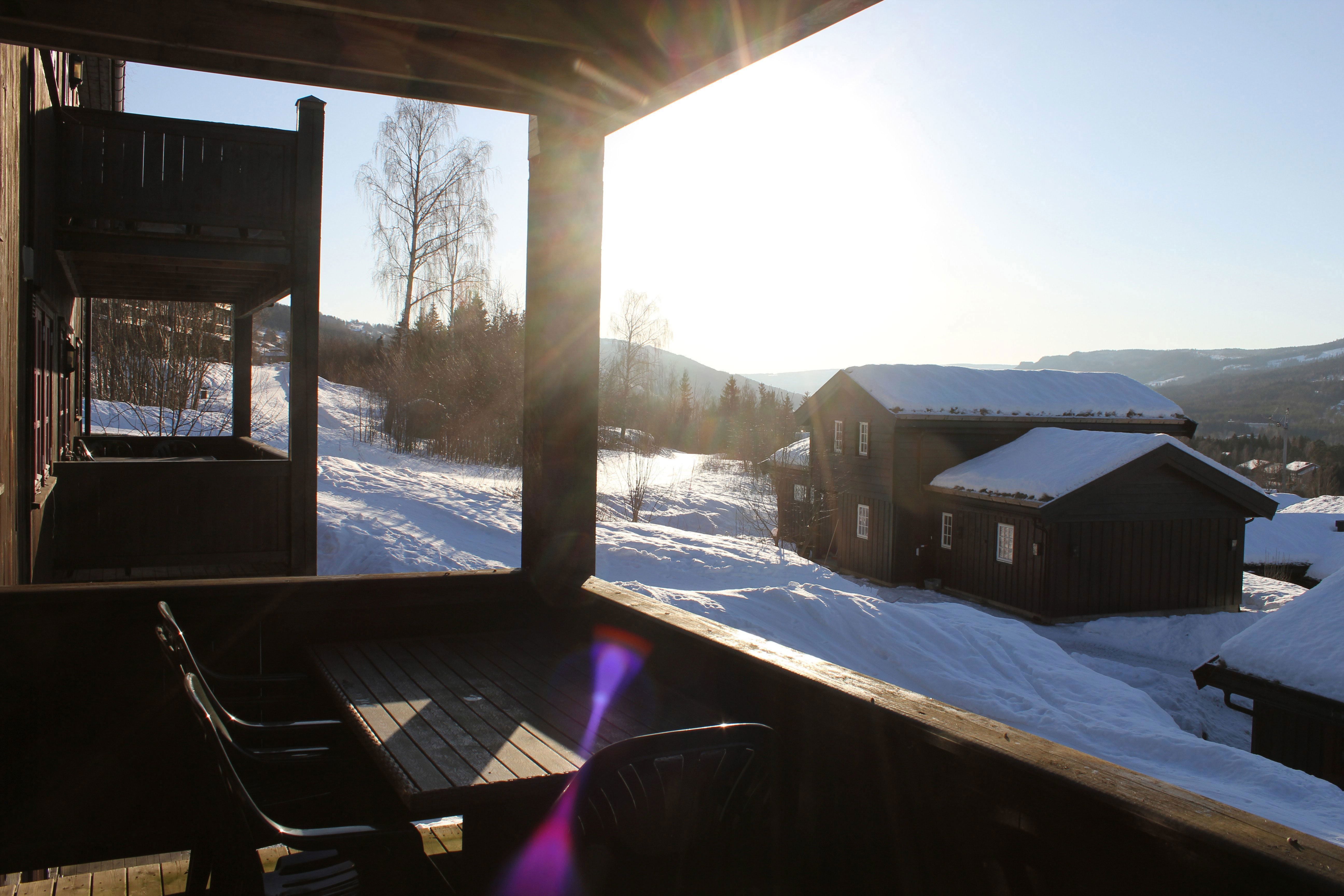 A terrace with table and chairs in the snow.