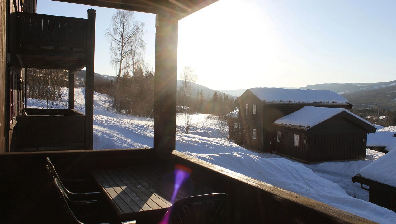 A terrace with table and chairs in the snow.