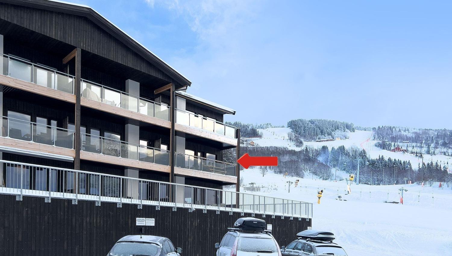 Cars parked cars in the snow.