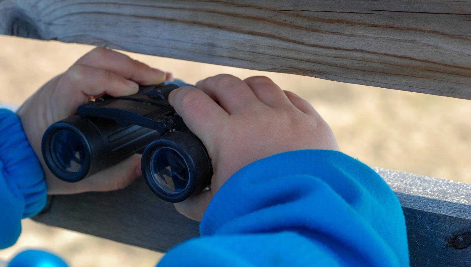 girl looking with binoculars