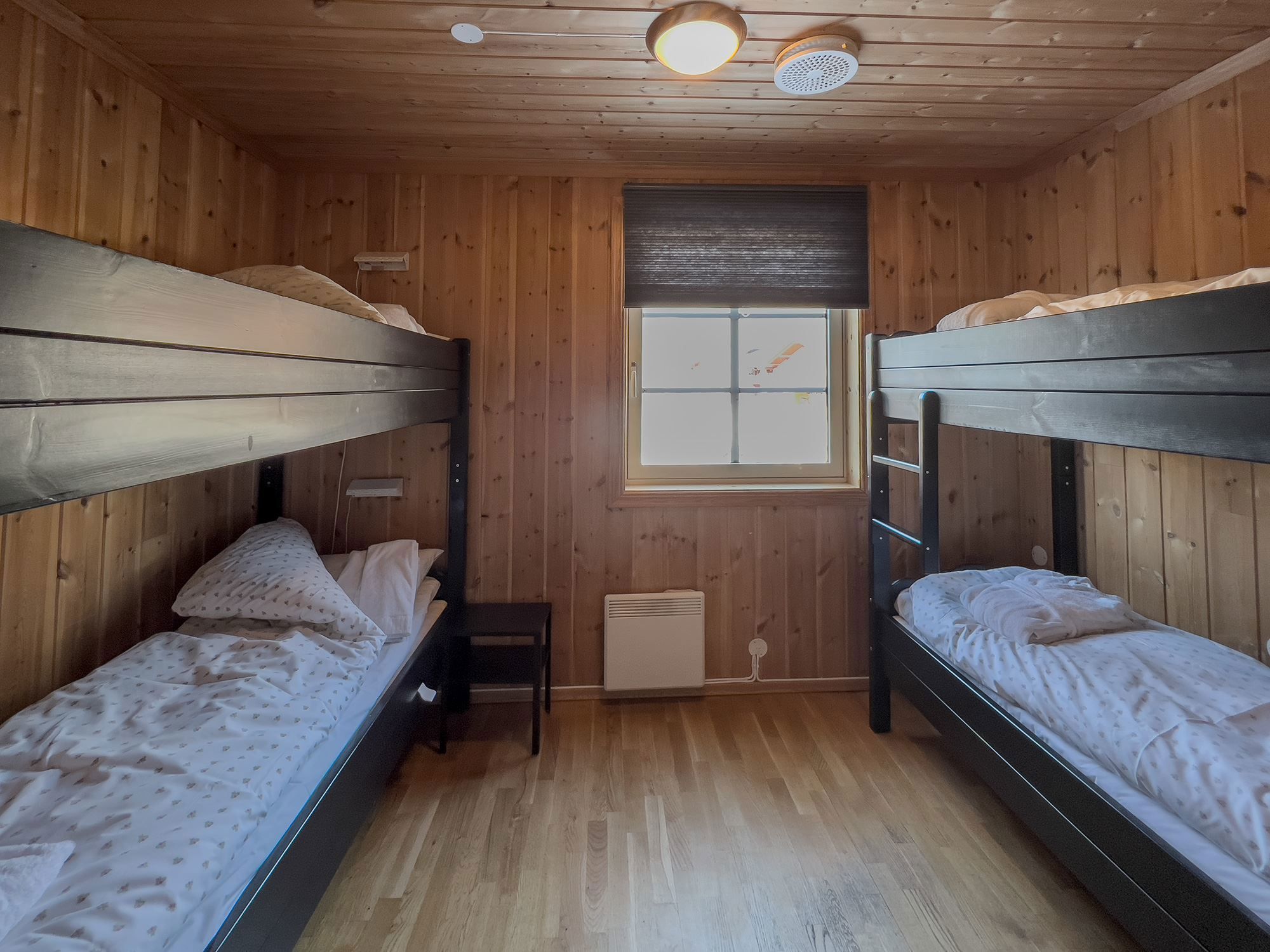 A room with bunk beds and a window.