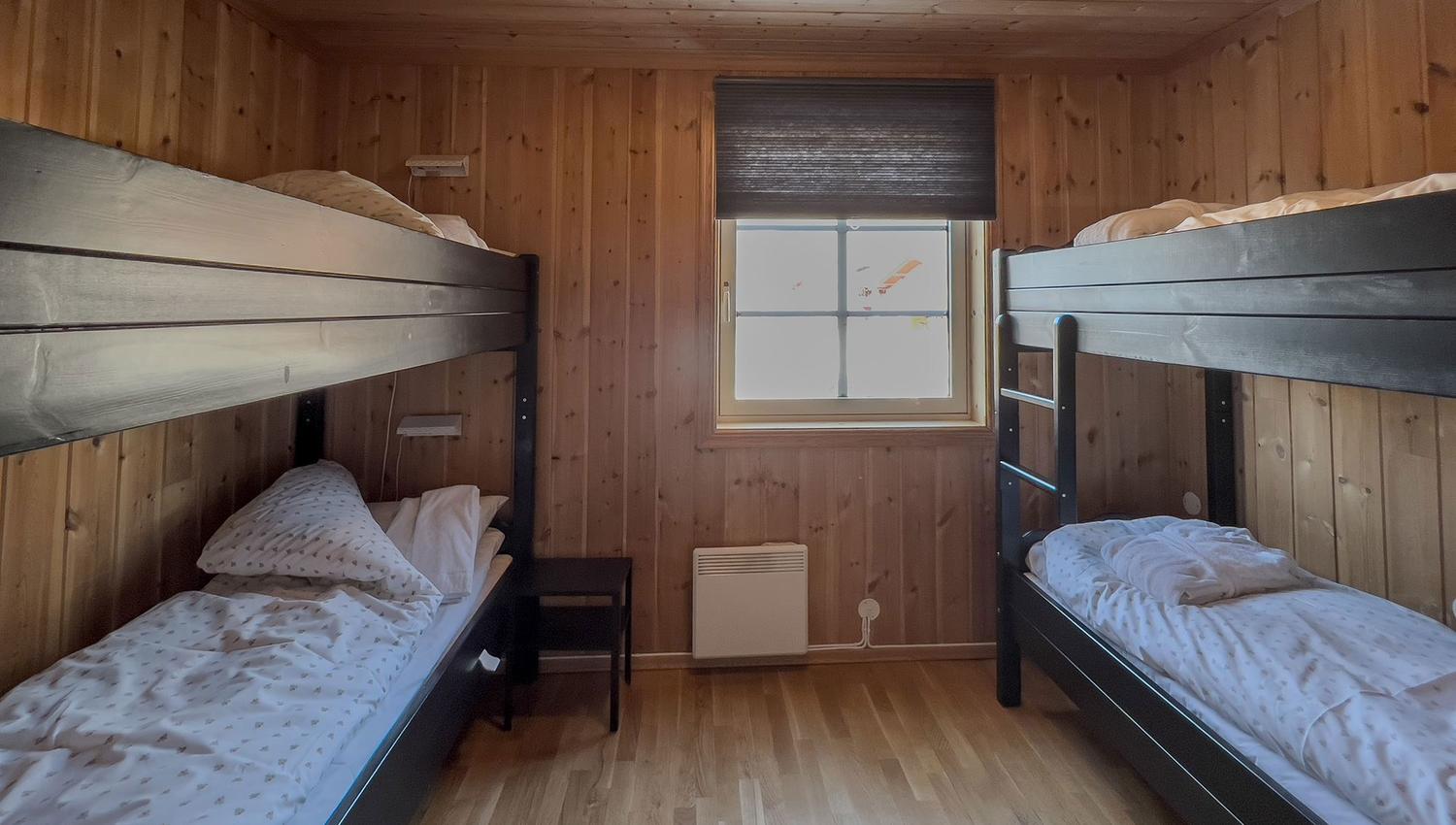 A room with bunk beds and a window.
