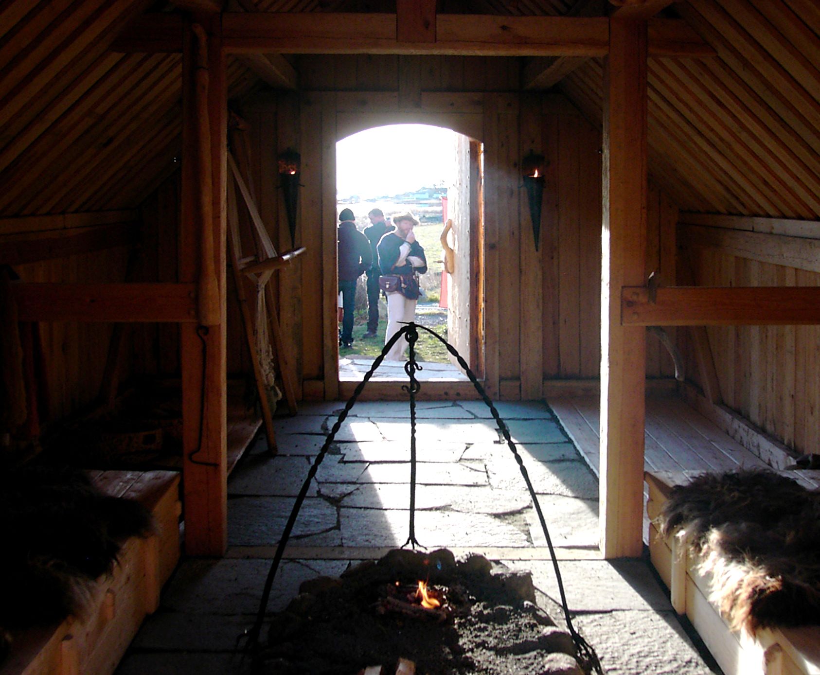 A hallway, fire and beds