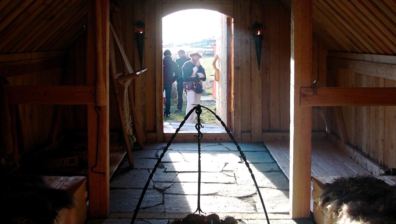 A hallway, fire and beds