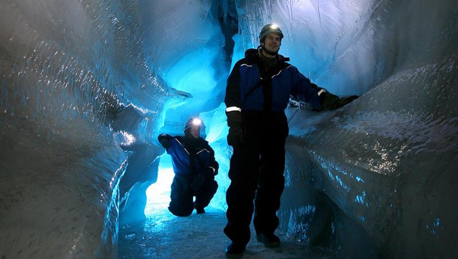 Two people in an ice cave