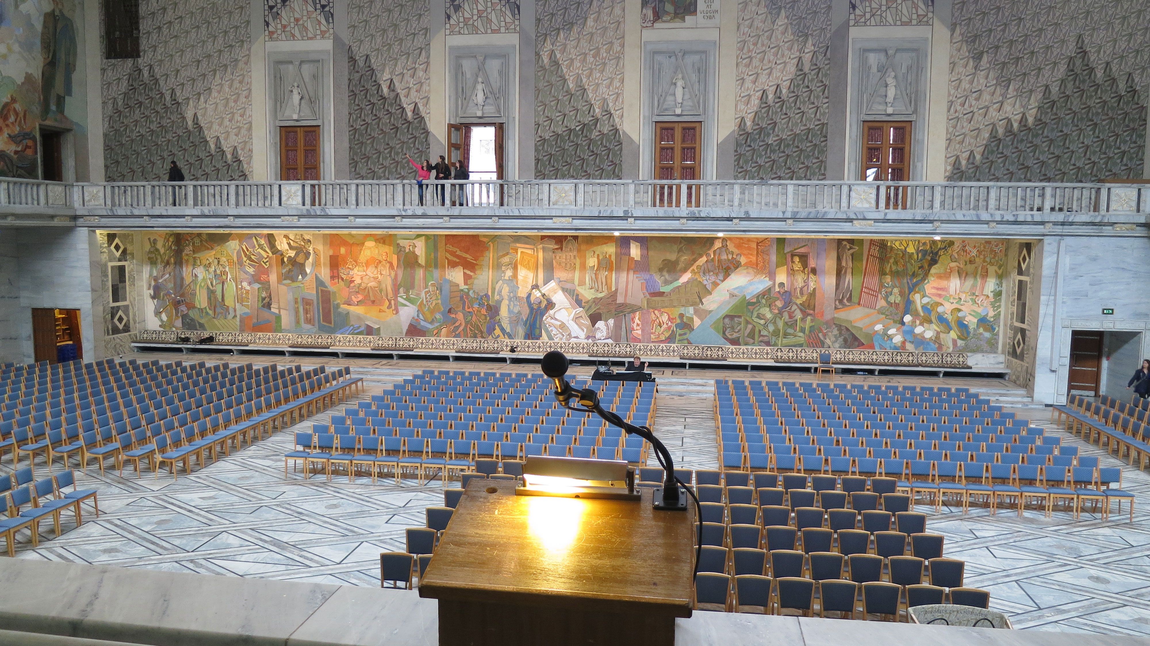 oslo city hall prepared for an event with many chairs facing a podium 