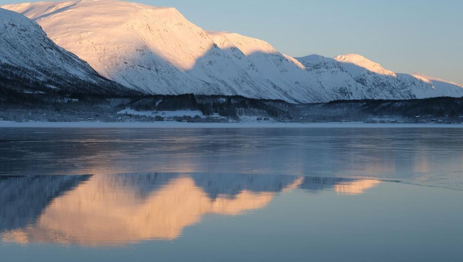 View of the fjord and snow covered mountains