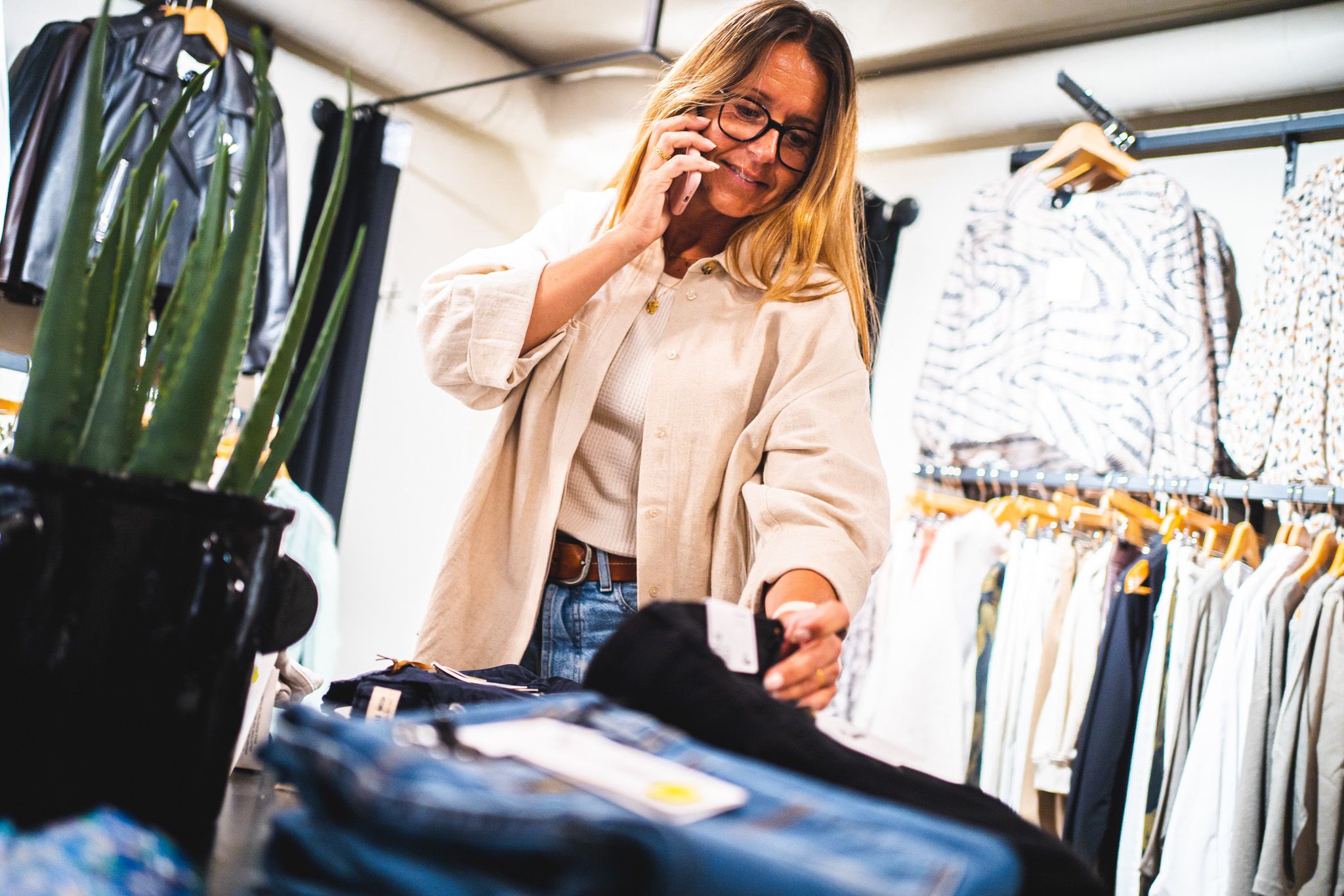 woman looking at pants in a store