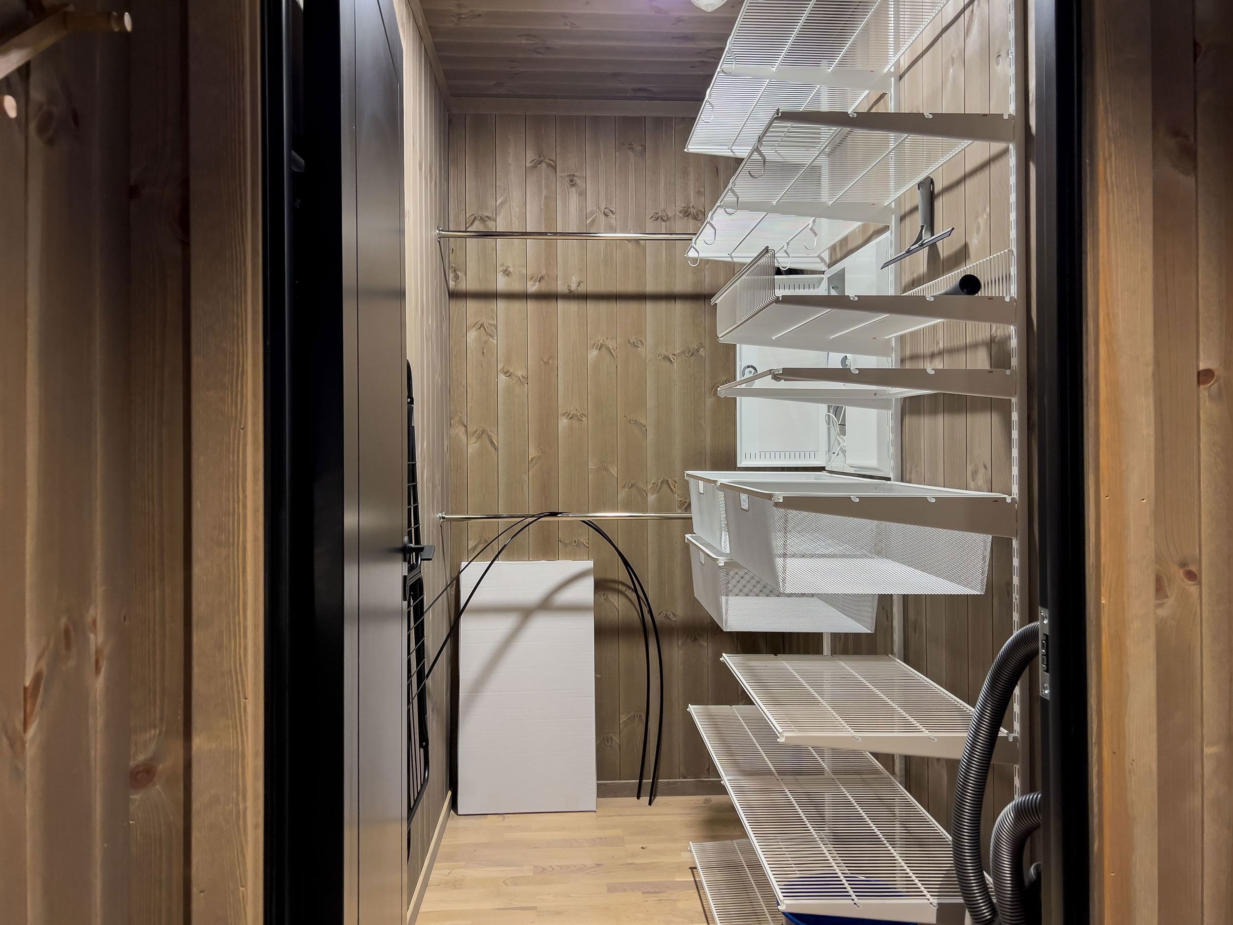 A room with shelves and a door.