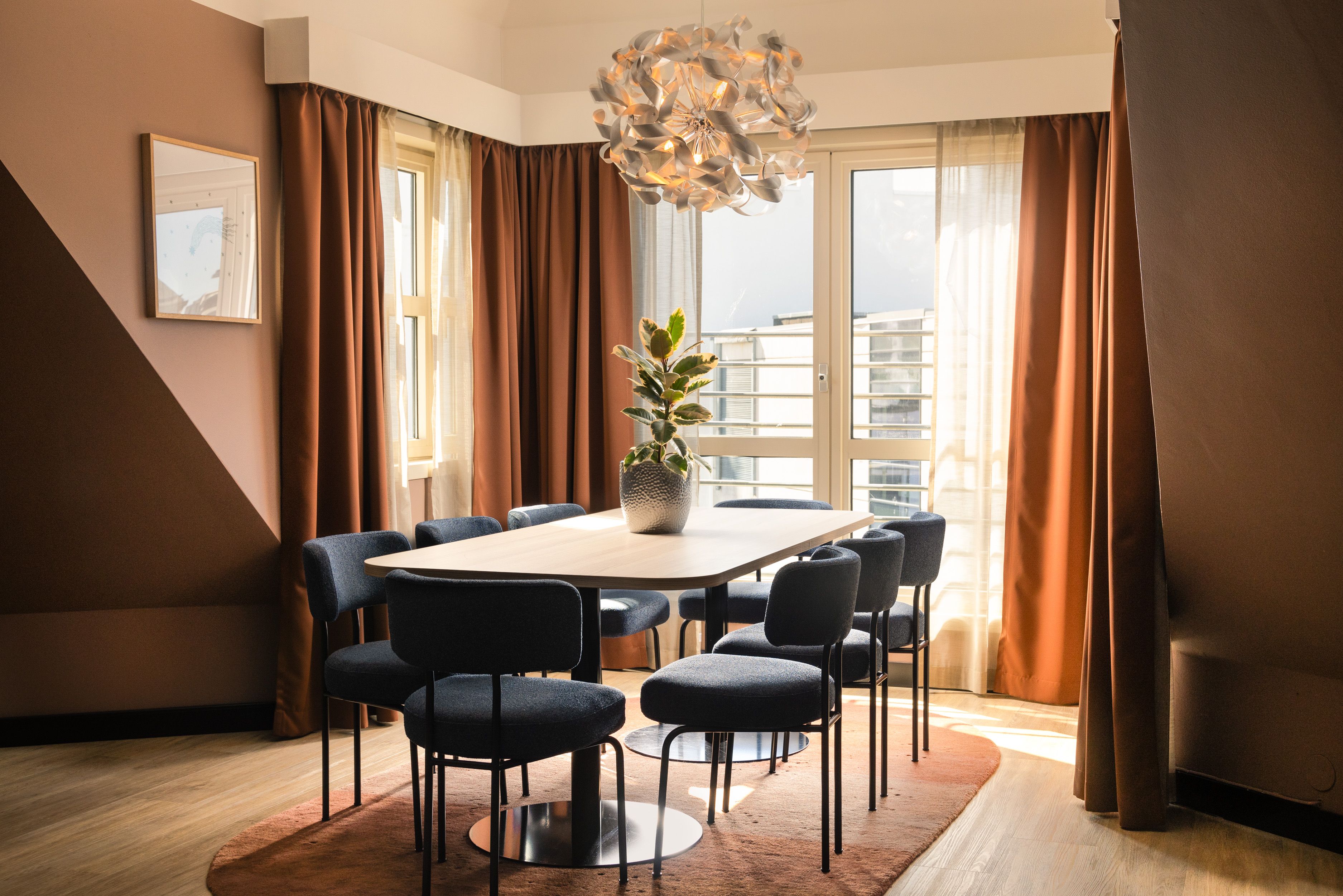 Long table with blue chairs and city views