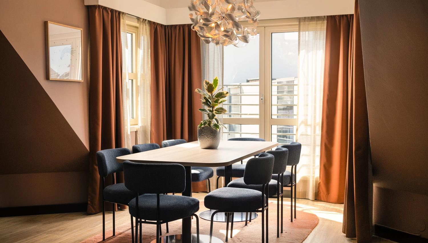 Long table with blue chairs and city views