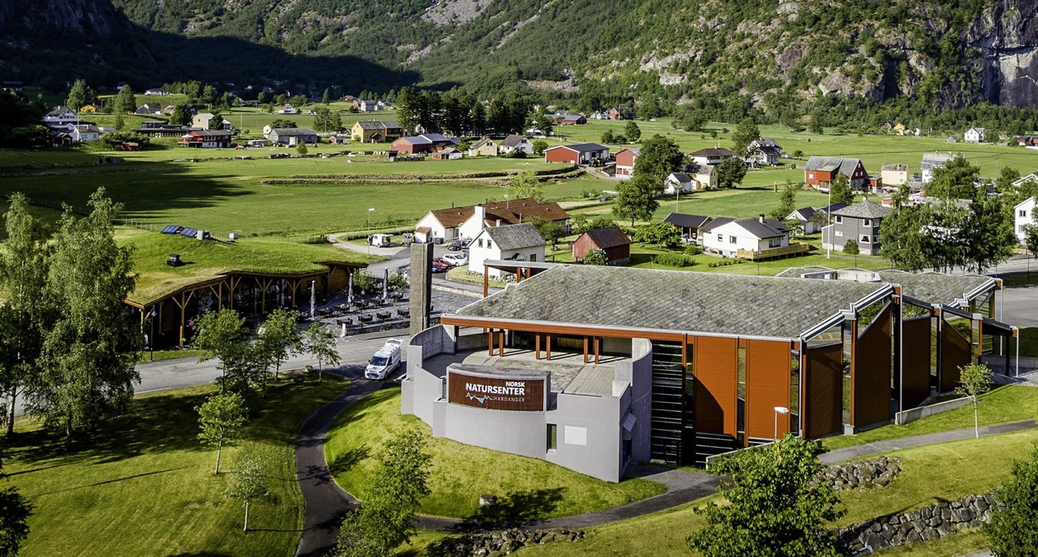 A drone photo of Norwegian Nature center with houses and farms in the background.