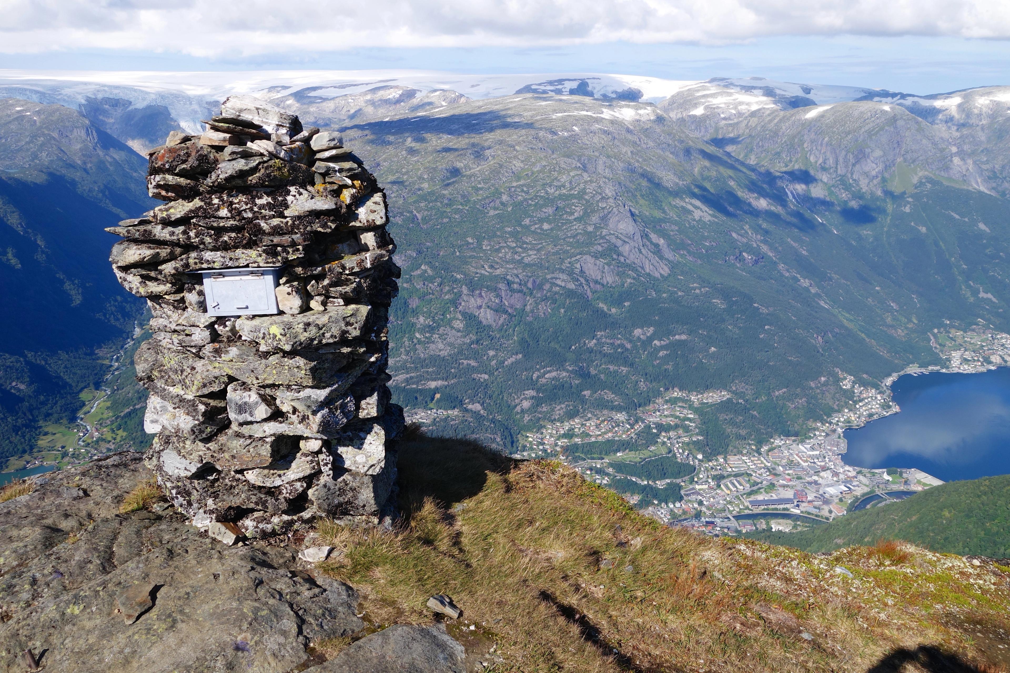 Cairn at the summit of Rossnos offering panoramic views over Odda and the mountains of Hardanger.