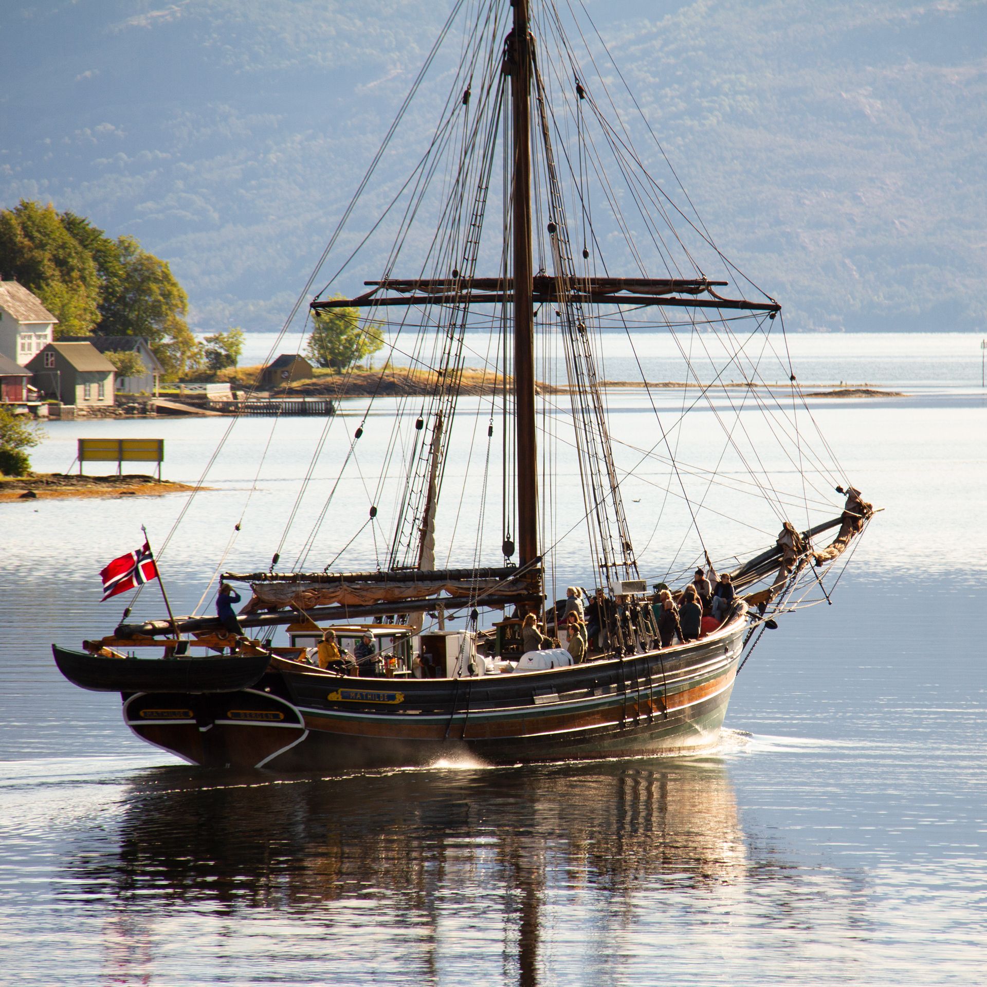 A sailboat sailing on Hardangerfjord near the Hardanger Maritime Center.