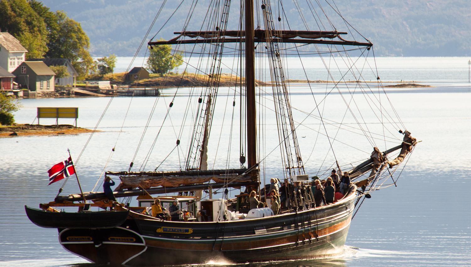 A sailboat sailing on Hardangerfjord near the Hardanger Maritime Center.