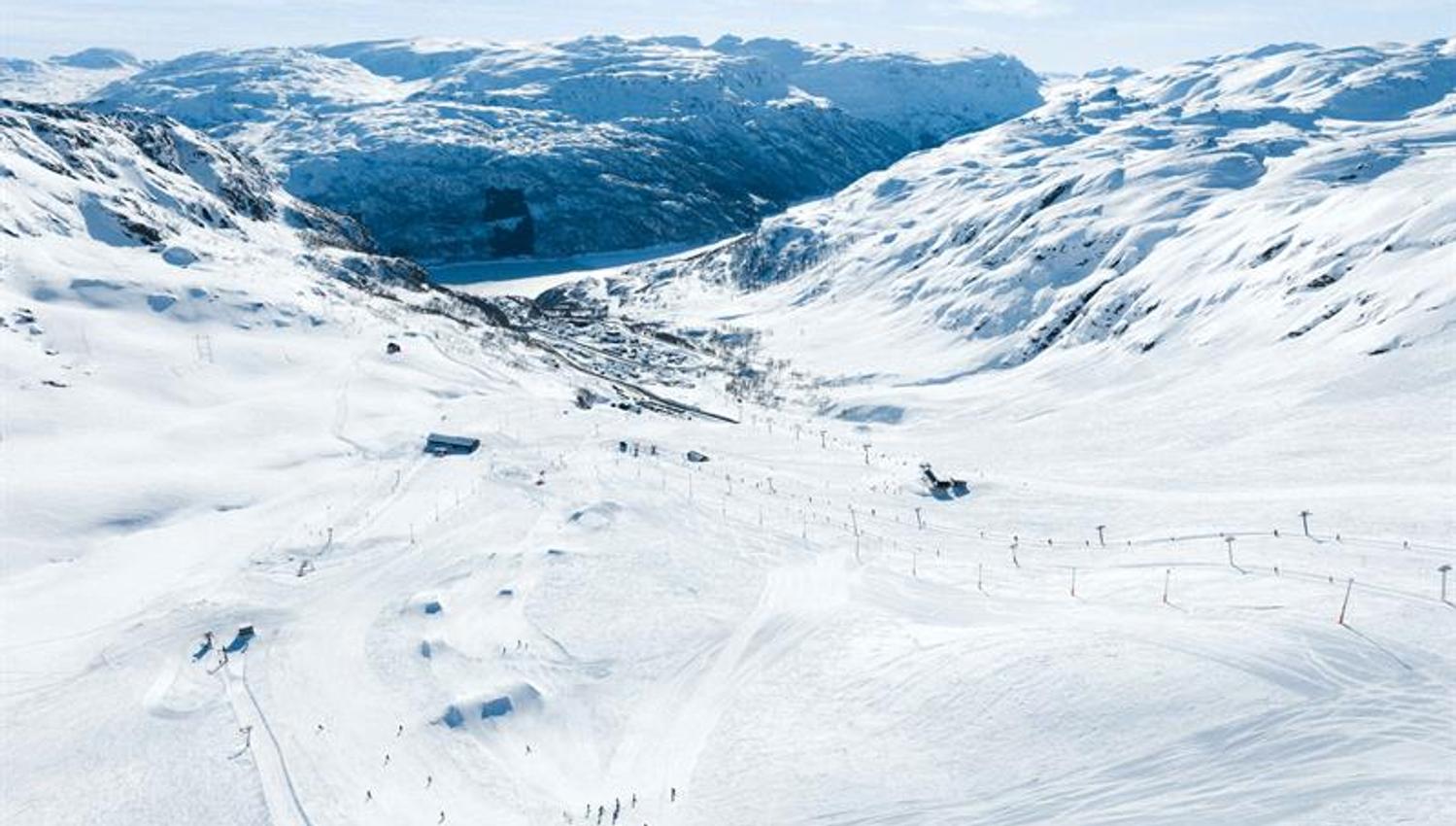 Panoramic view of Røldal Ski Resort surrounded by snow-covered mountains and the fjord in Hardanger.