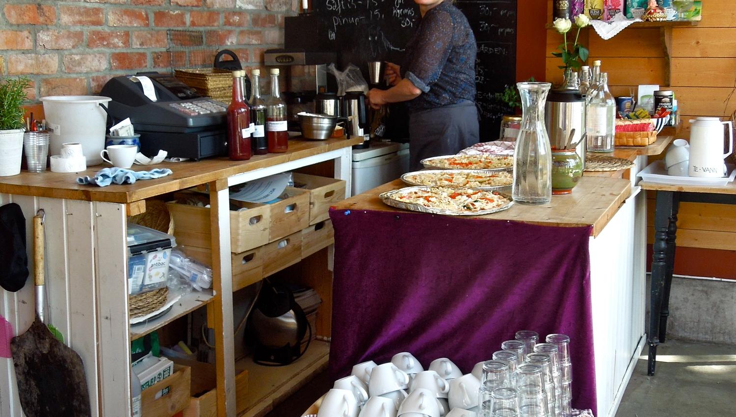 Inside Holt Gård cafe, with the smiling owner