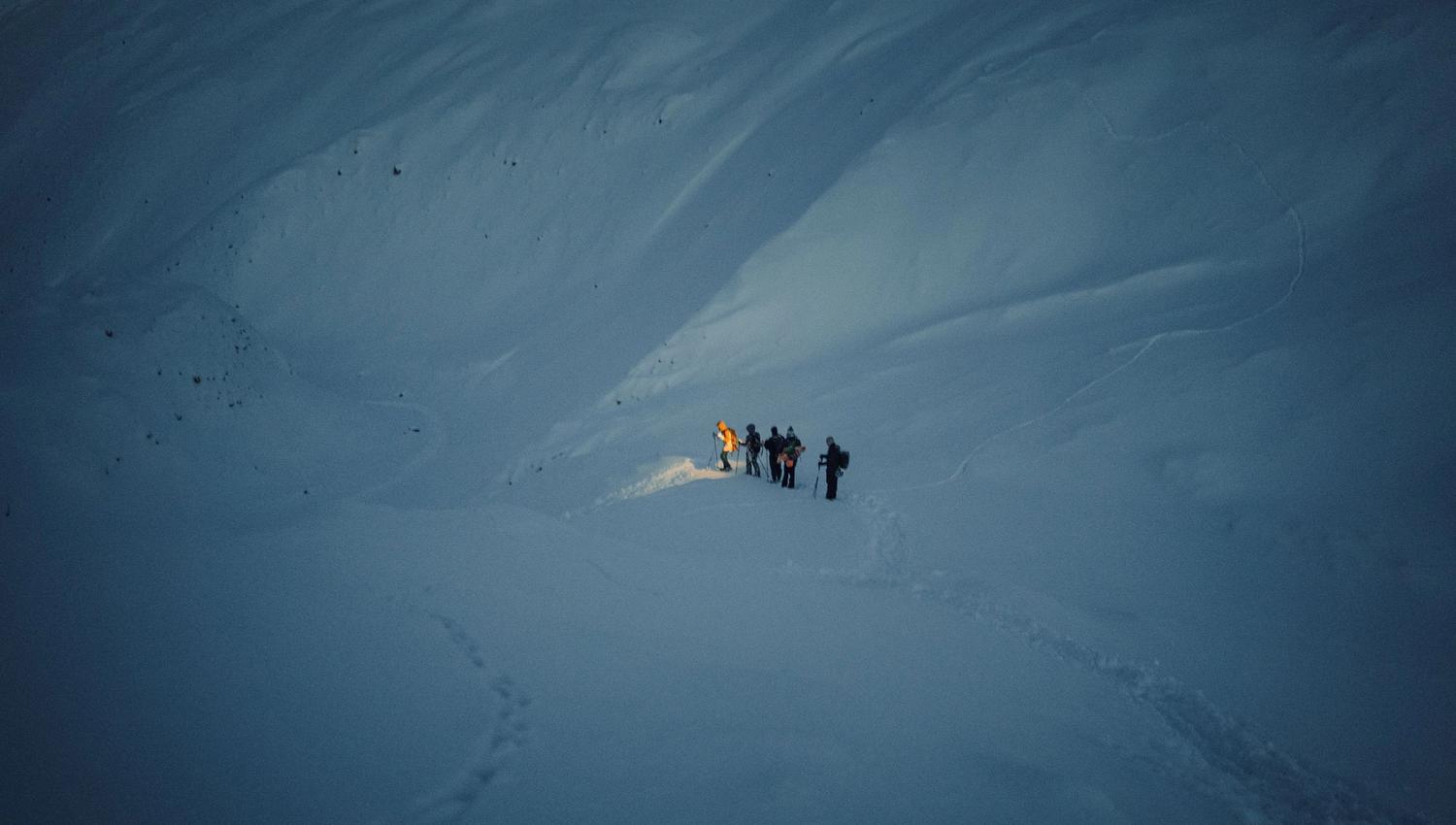 People waling on a glacier