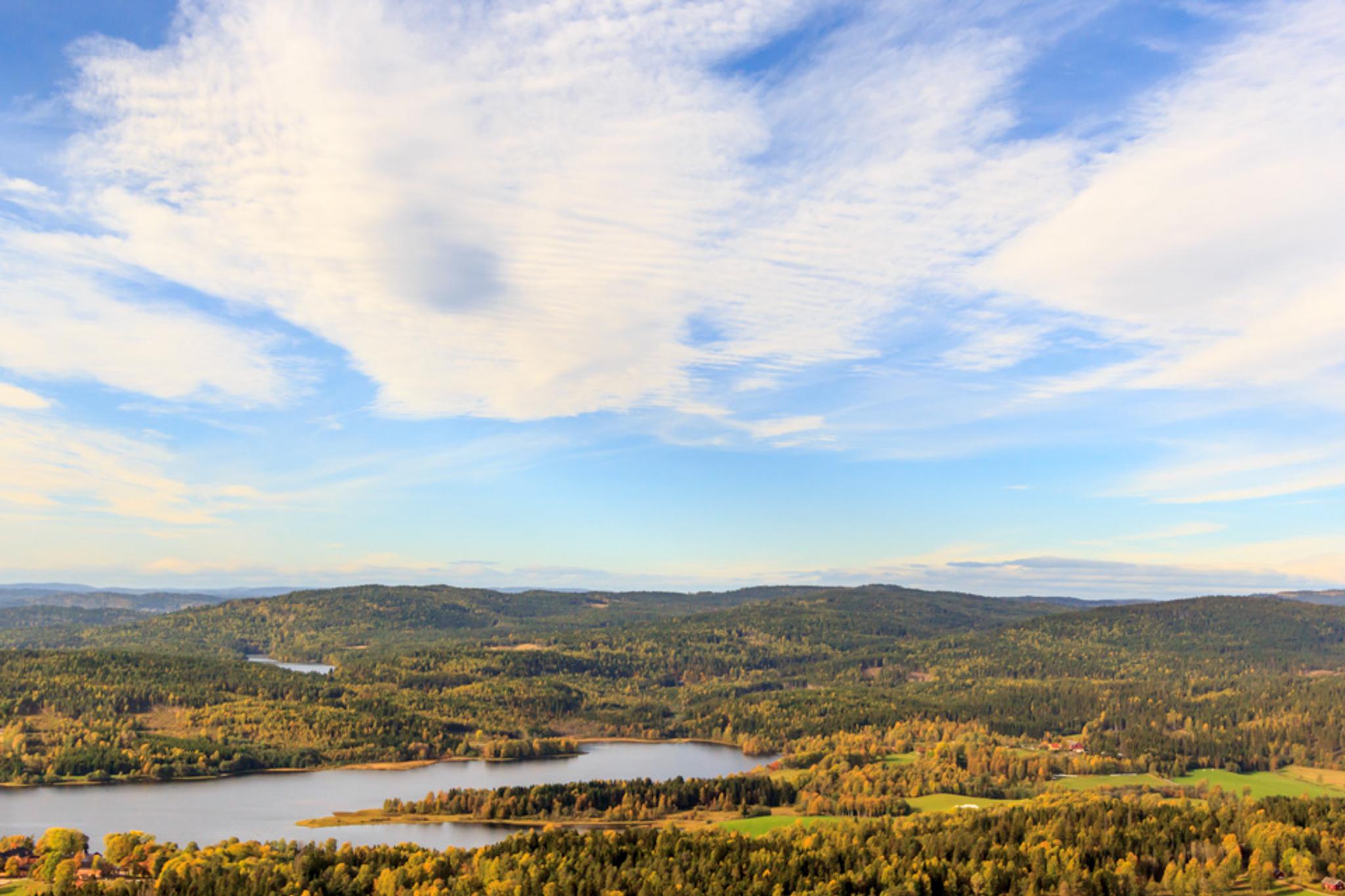 Blue sky with clouds over an idyllic natural landscape.