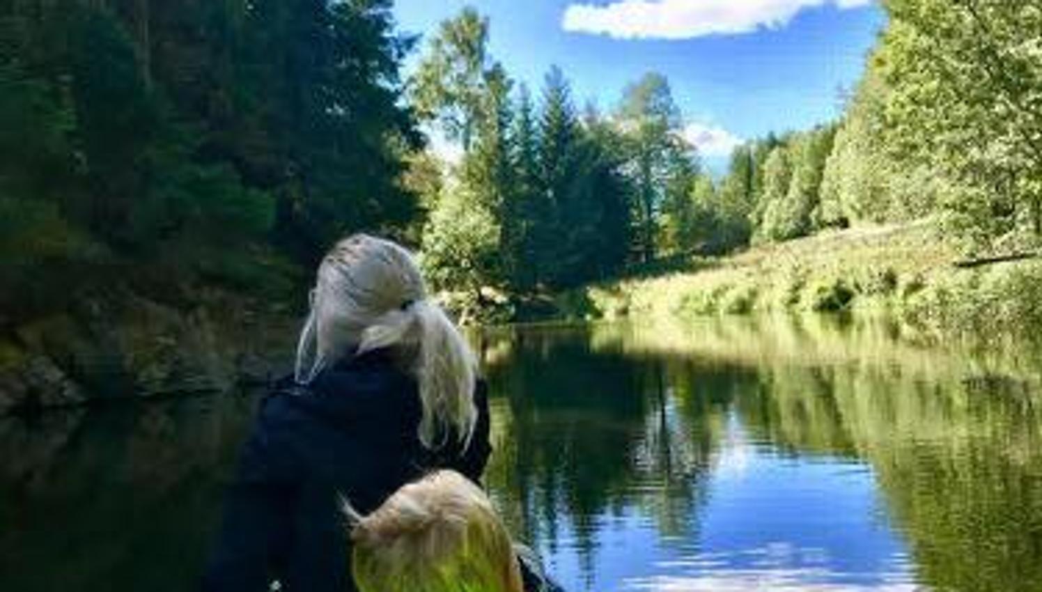 Child and adult paddling canoe