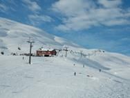 Ski joy in the sunny slopes of Røldal Ski Resort with perfect snow conditions.