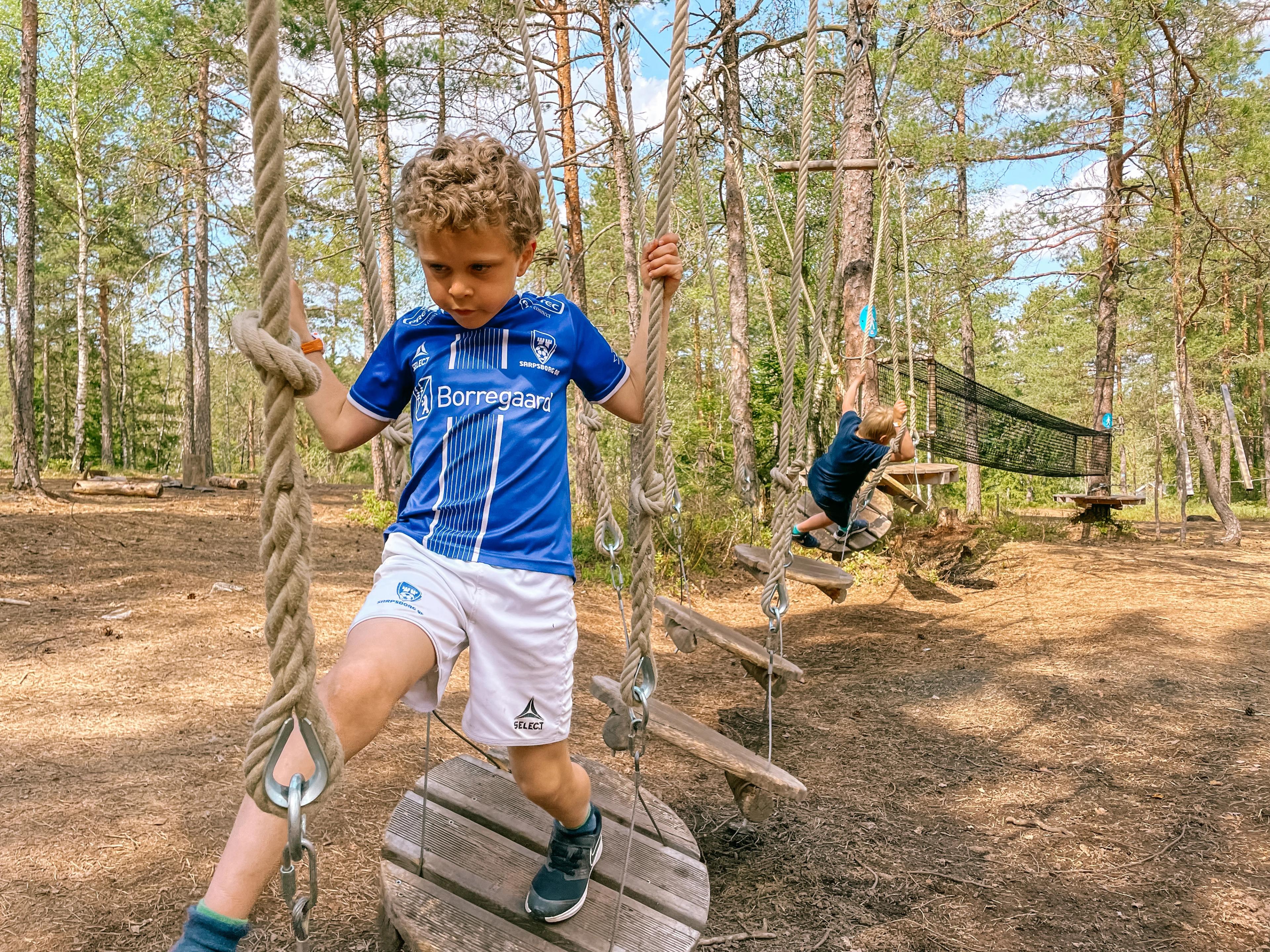 Photo, Boy trying to come through at an obstacle course