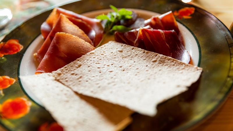 plate with sour cream porridge  and ham 