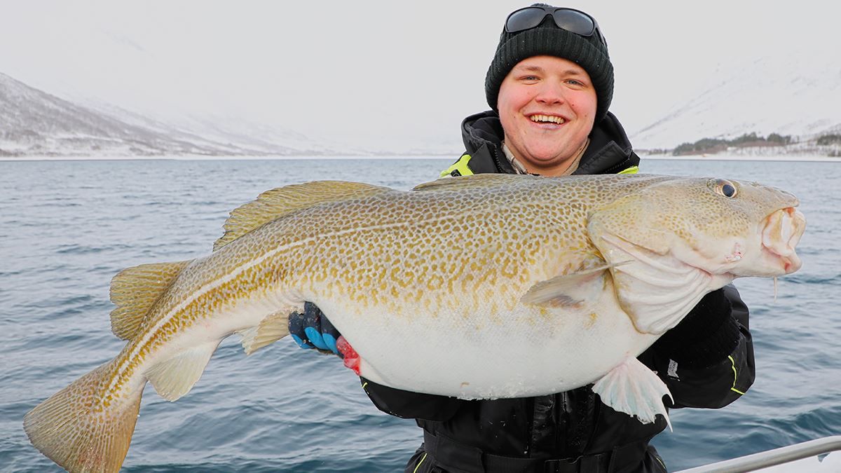 A guest holding a fish