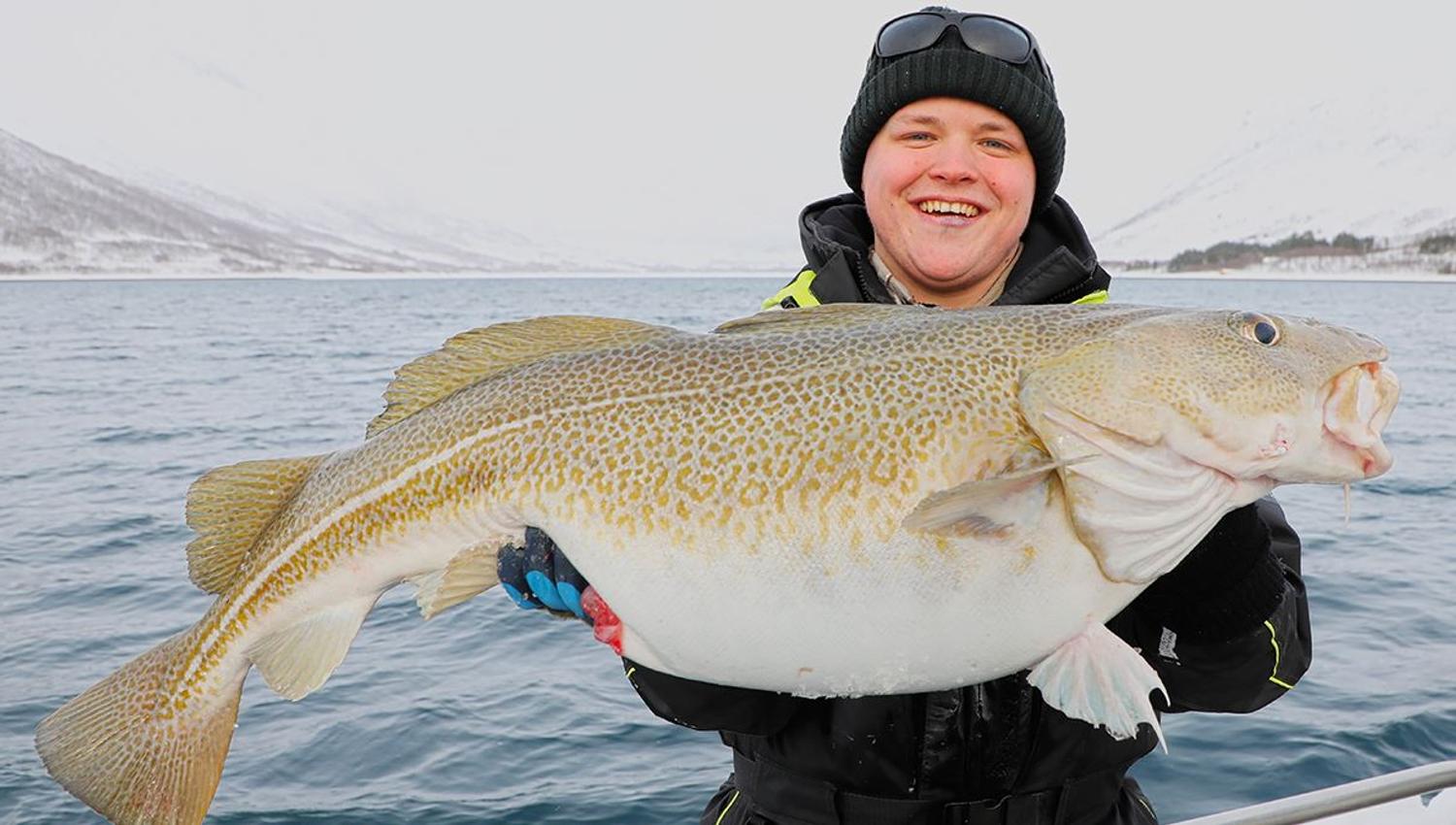 A guest holding a fish