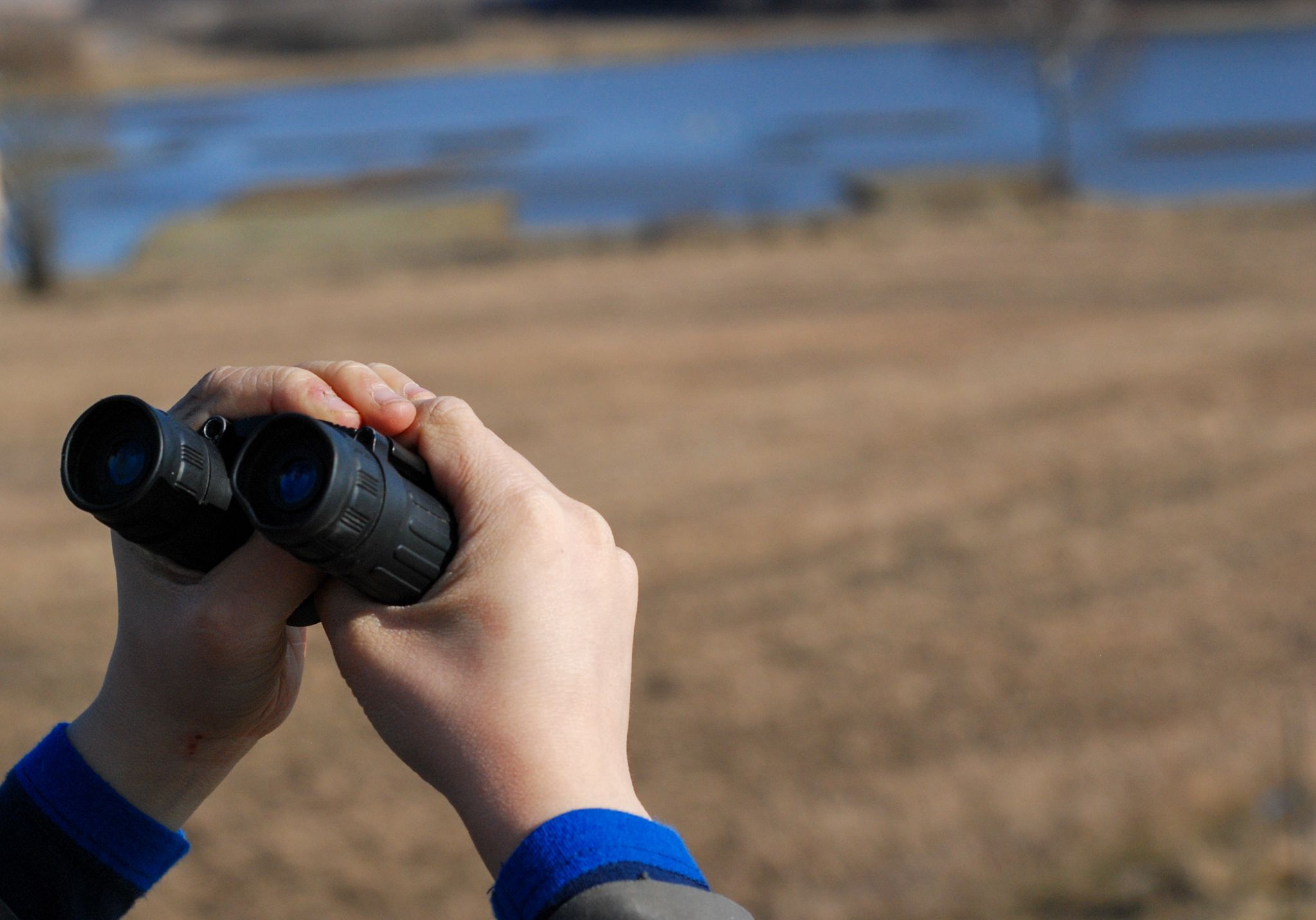 person looking with binoculars