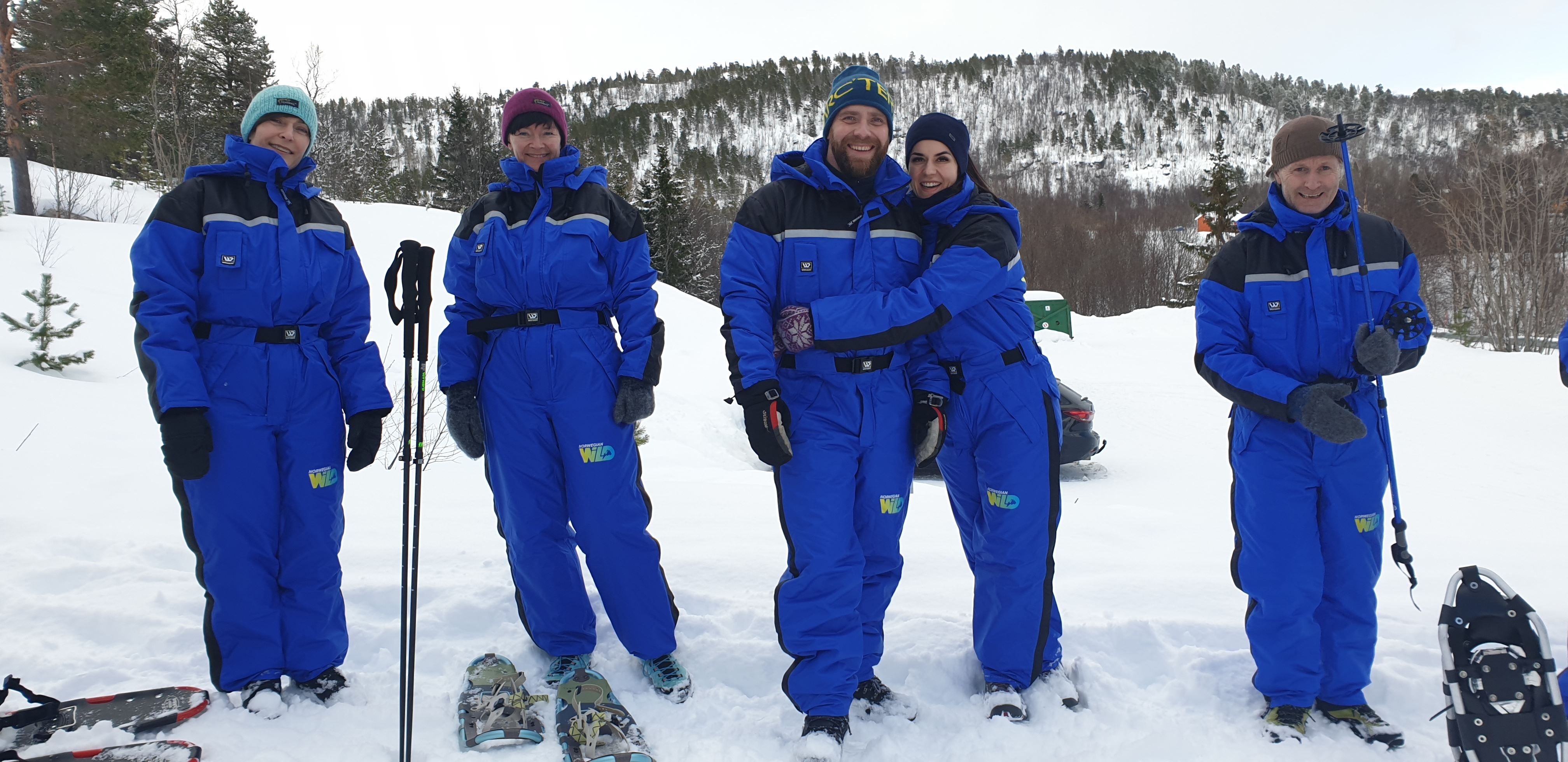 group of people on a snowshoe trip in a winter landscape