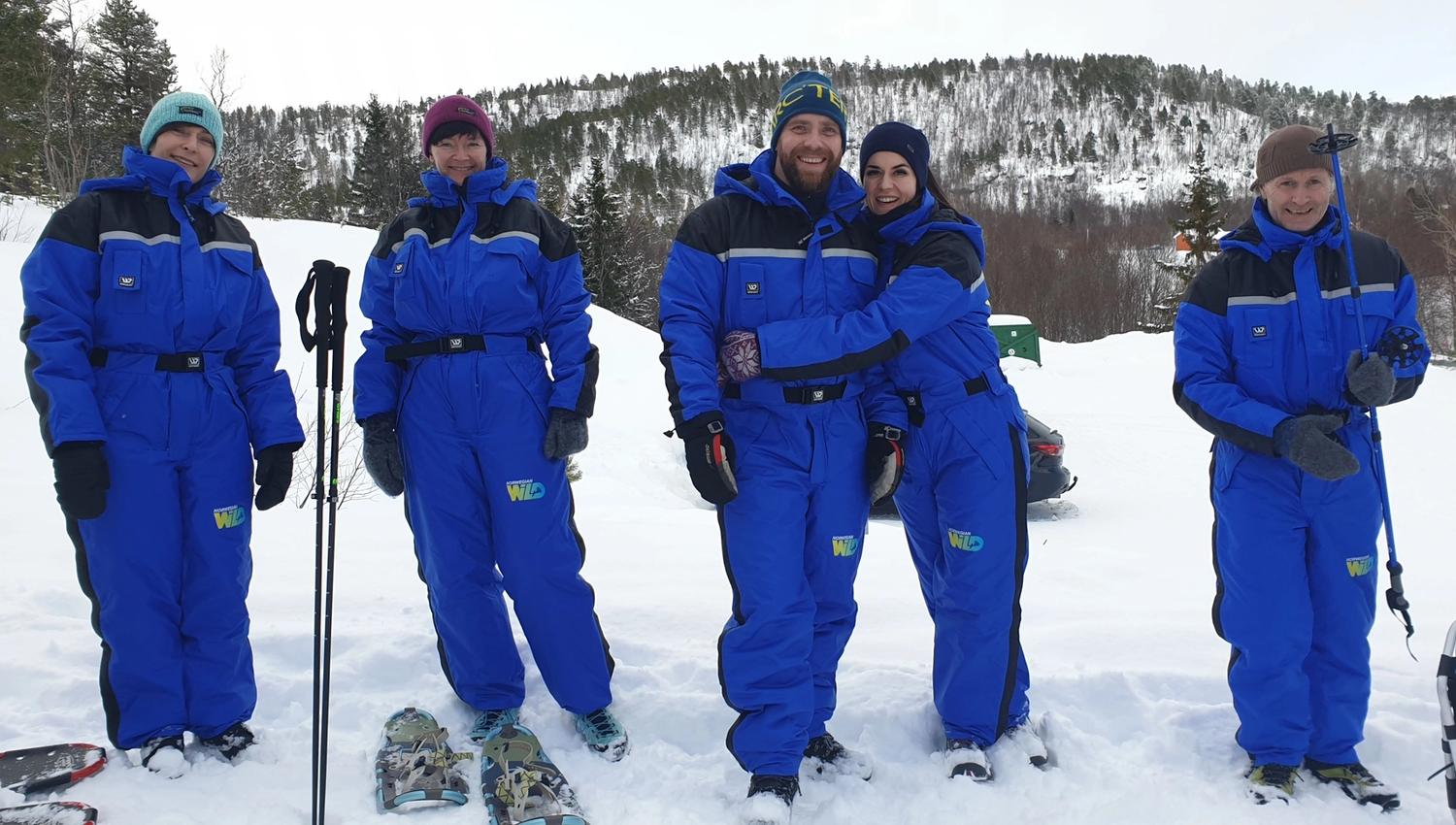group of people on a snowshoe trip in a winter landscape