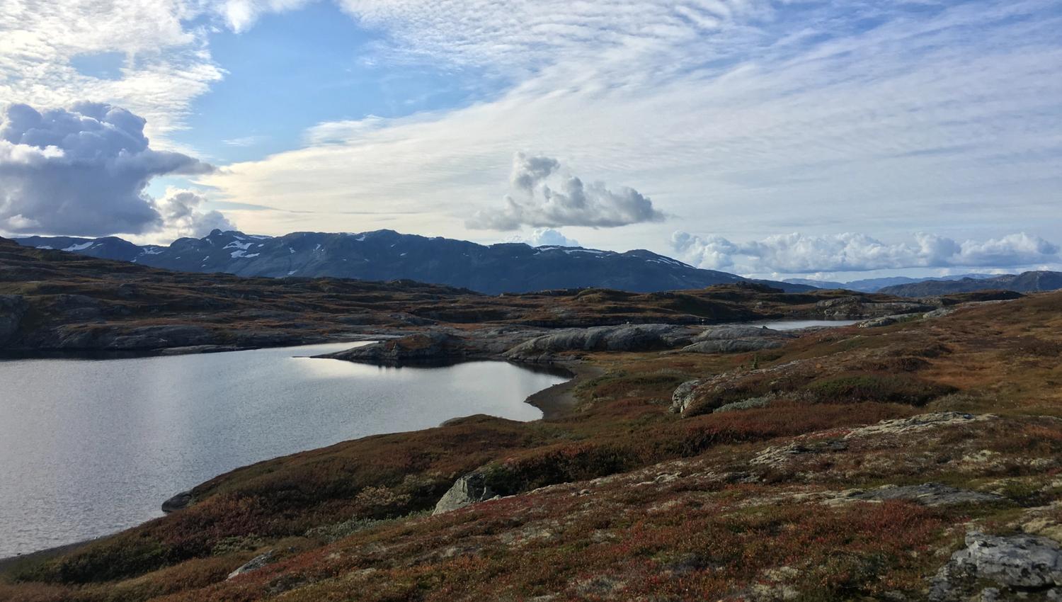 Mountain lake and open plateau with dramatic sky on Hardangervidda.