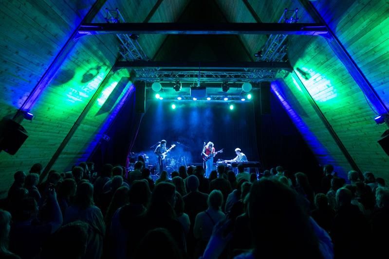 artists on stage and full audience area during a concert at SALT