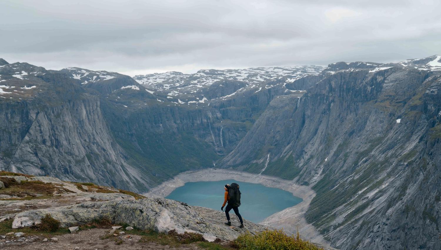 Vandraren ser utover den spektakulære utsikta ved Trolltunga i Hardanger.
