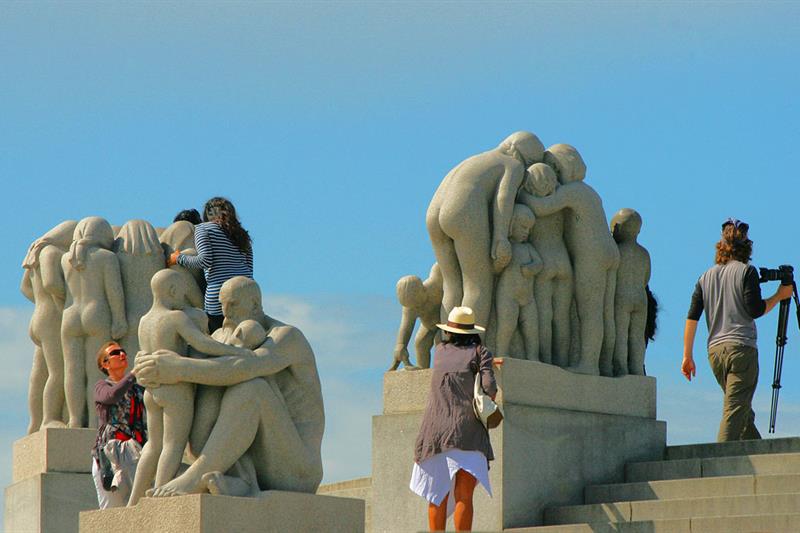 people taking photos with the statues 