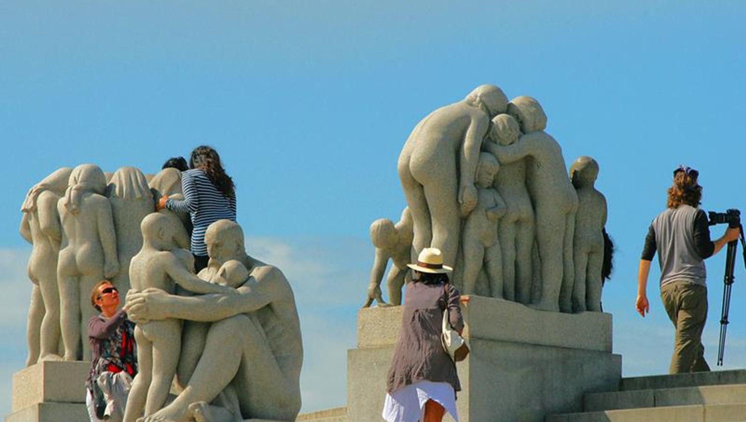 people taking photos with the statues