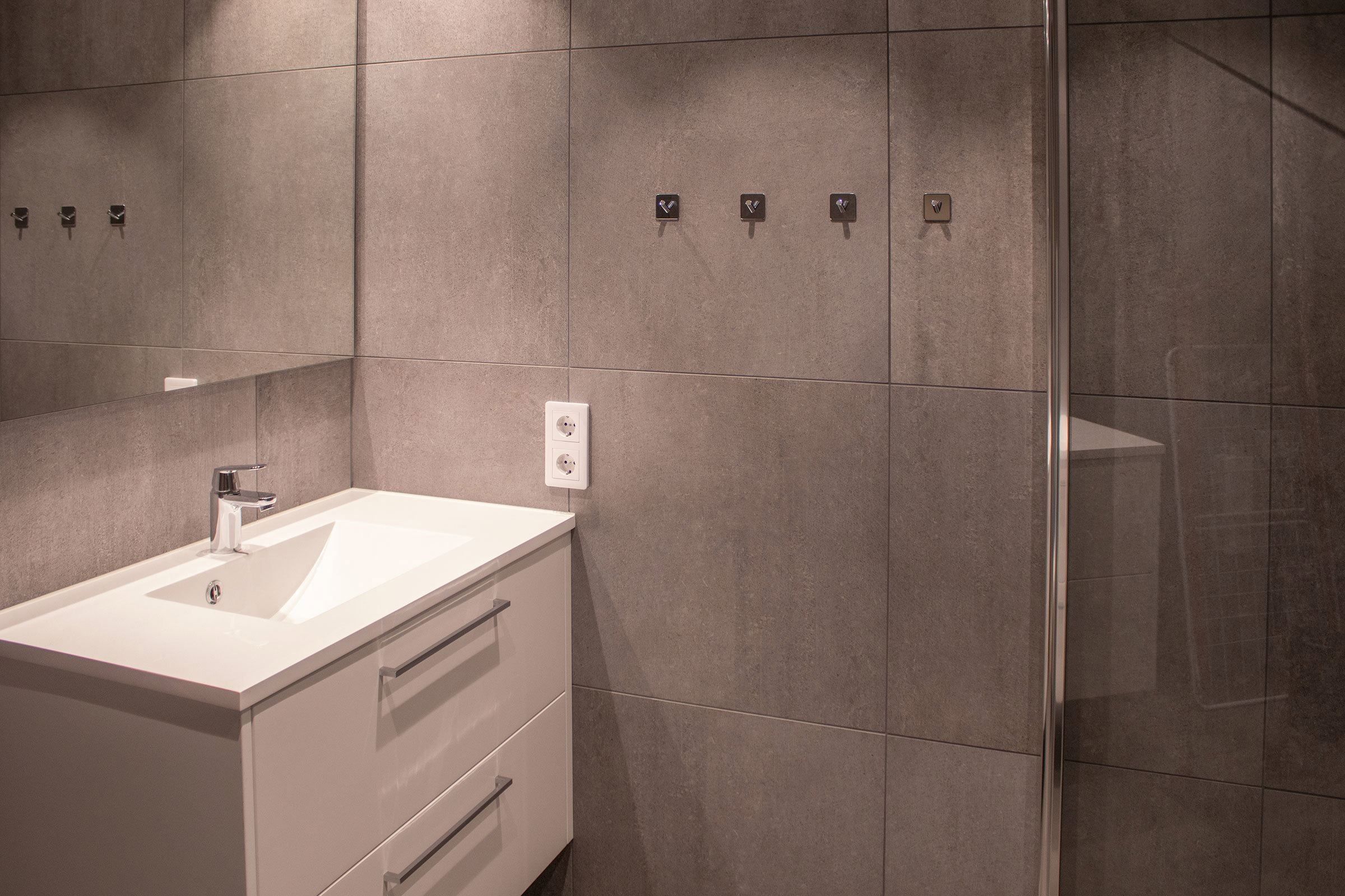 A bathroom with shower and sink.