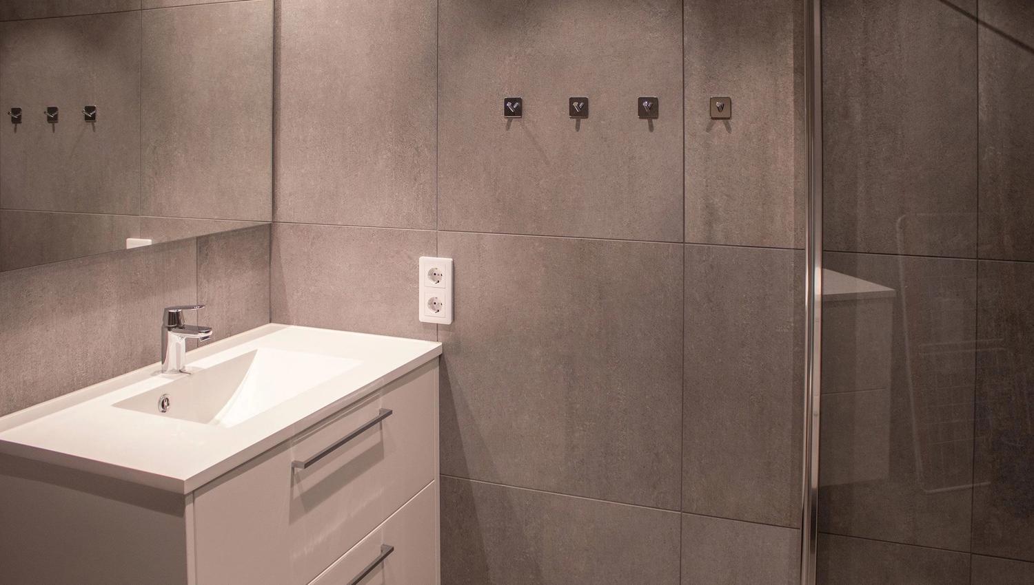 A bathroom with shower and sink.