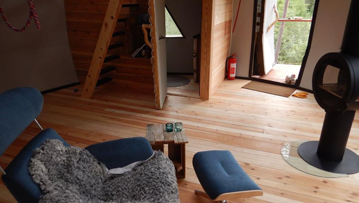 A chair in front of the wood stove