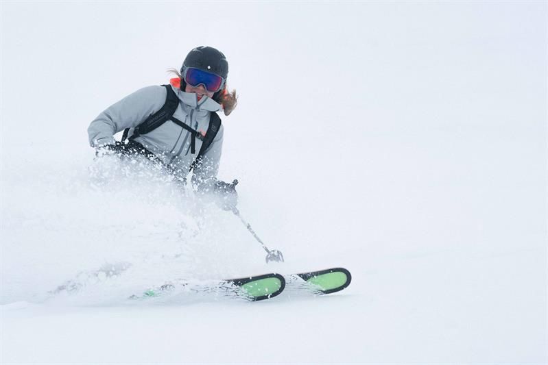 Skier in action carving through powder snow at Røldal Ski Resort in Hardanger.