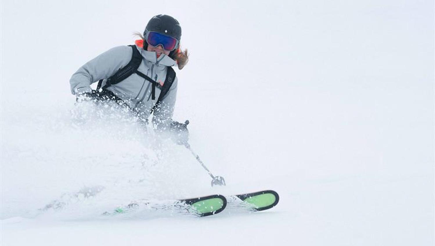 Skier in action carving through powder snow at Røldal Ski Resort in Hardanger.