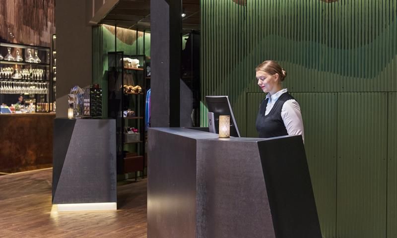 A receptionist working on a computer in a hotel reception