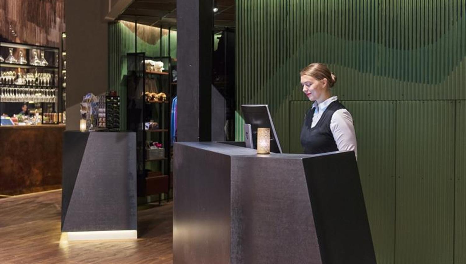 A receptionist working on a computer in a hotel reception