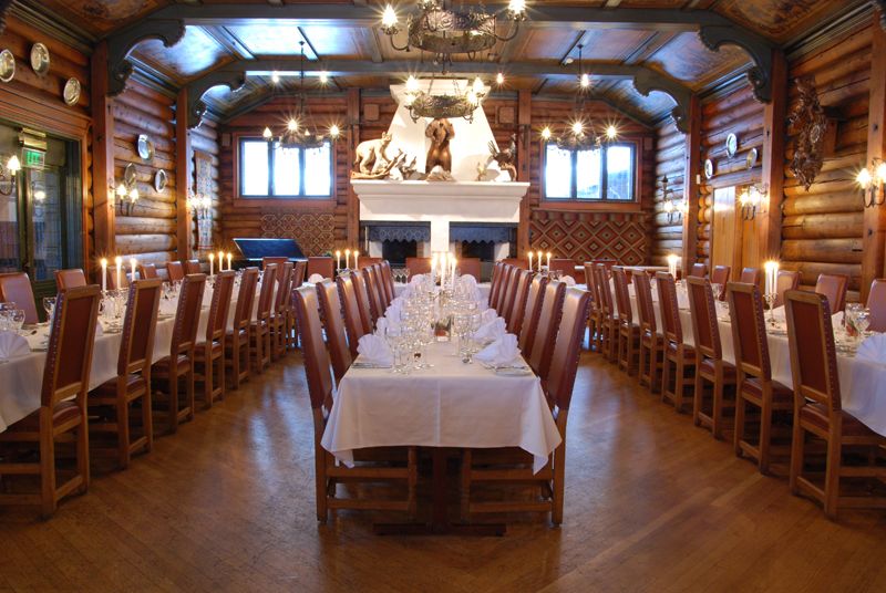 Dining hall with set tables and chairs.