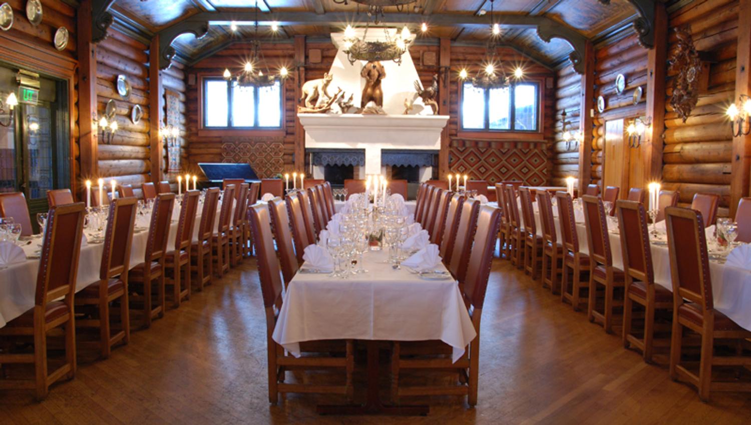 Dining hall with set tables and chairs.