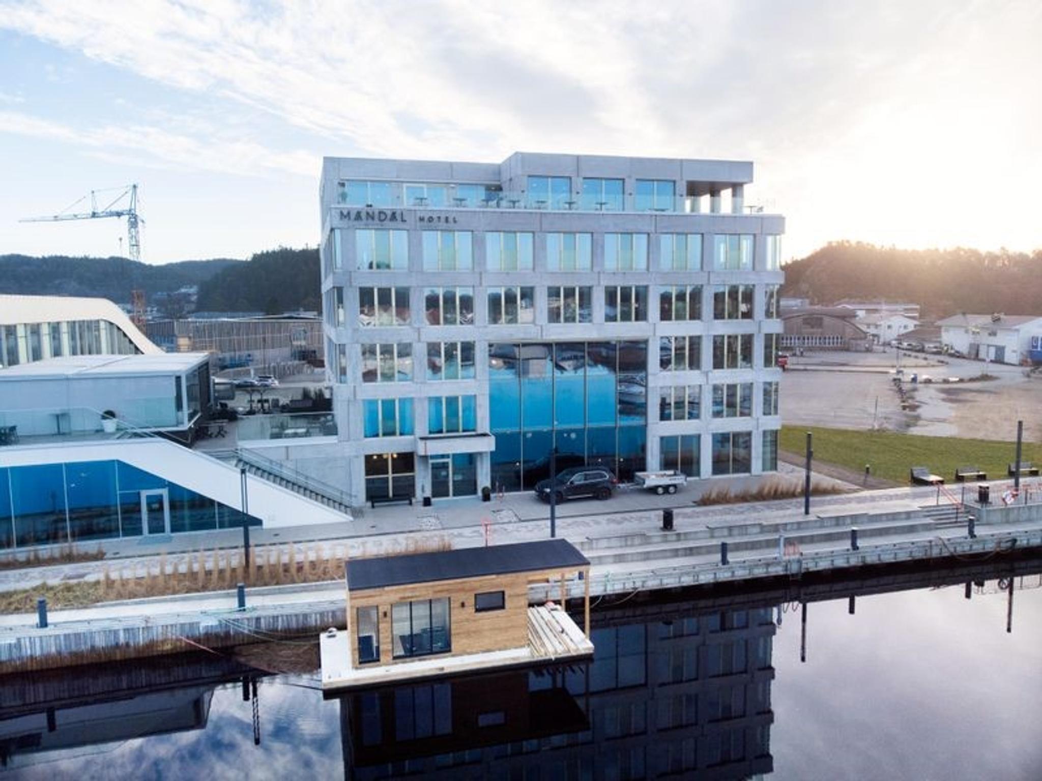 Oversiktsbilde av Mandal Hotel og badstubåten Pysen som ligger i Mandalselva